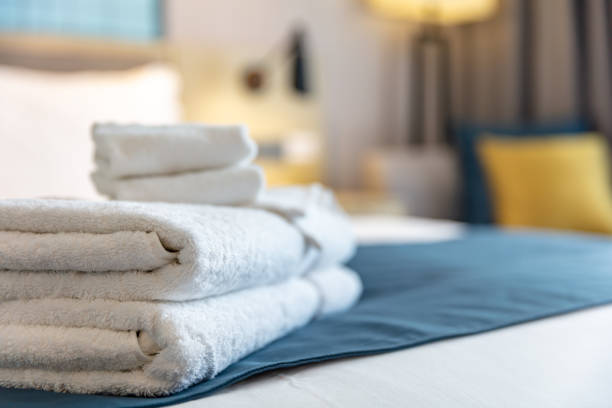 istock Clean towels on bed at hotel room 1496565395