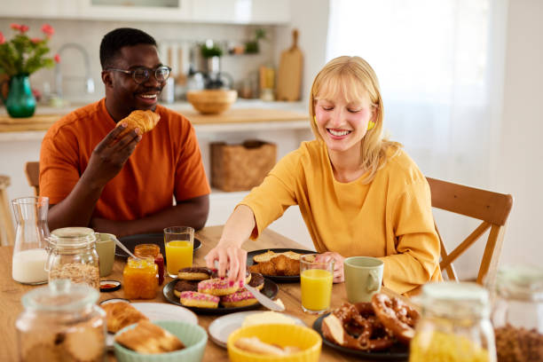 istock Multiracial couple enjoying breakfast together at home 1496568727