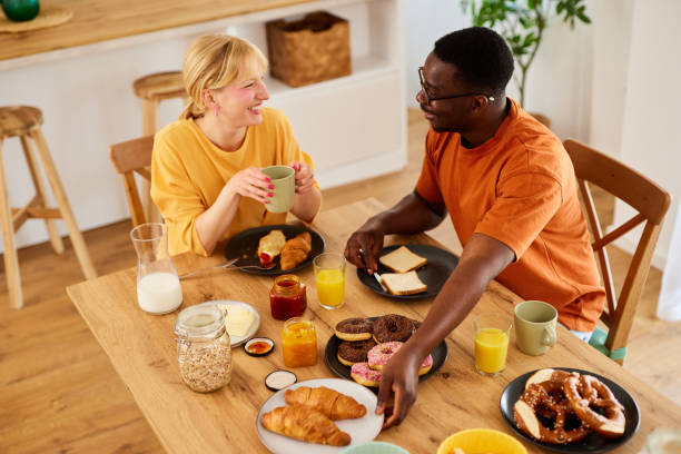 istock Multiracial couple enjoying breakfast together at home 1496568748