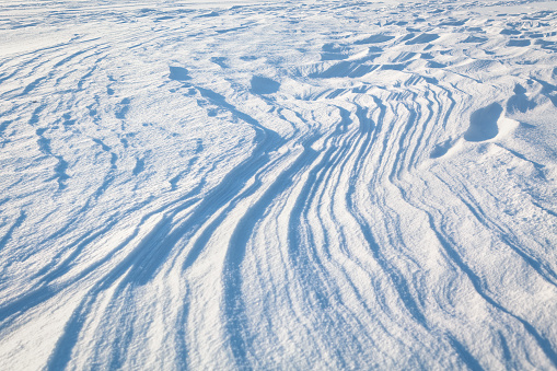 Snow waves surface . White winter snow background