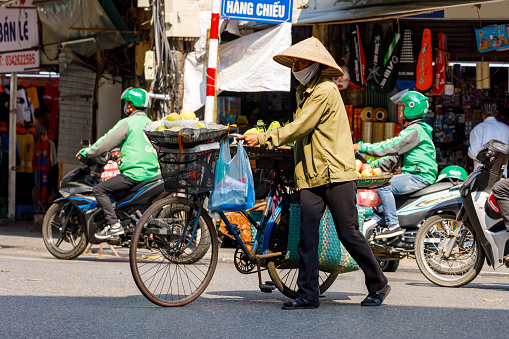 Hanoi, Bac Bo, Vietnam - November 25, 2019: Woman at the street market of Hanoi in Vietnam