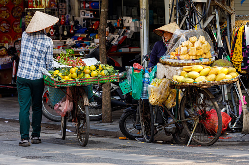Hanoi, Bac Bo, Vietnam - November 25, 2019: The street market women in Hanoi