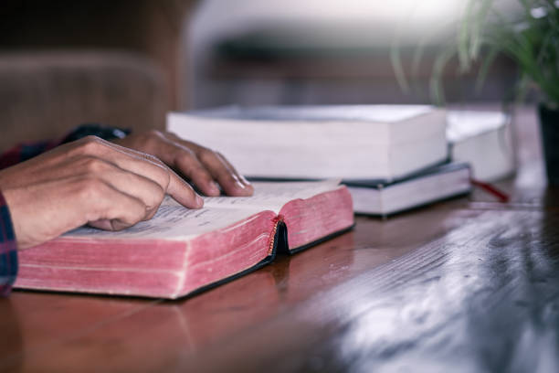 istock Hands of an unrecognizable man with Bible reading, Christian concept. 1496572972
