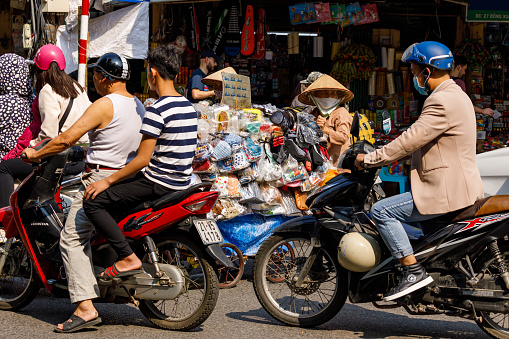 Hanoi, Bac Bo, Vietnam - November 25, 2019: Traffic of Mopeds in the streets of Hanoi