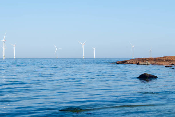 istock Windmills in the sea next to the stone coast 1496573313