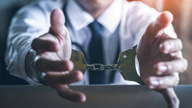 istock Business man cheating in handcuffs, punishment for corruption, business concept. 1496573743