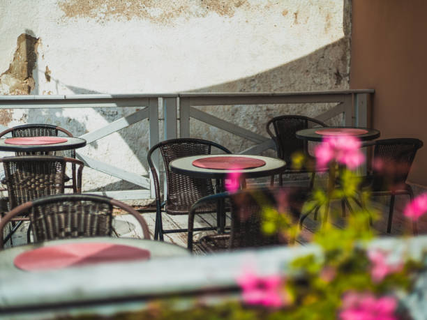 istock terrace tables and chairs in a small cafe 1496574990