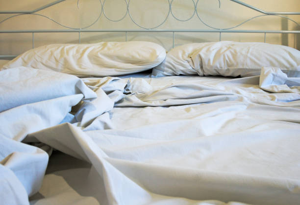unmade bed stock photo