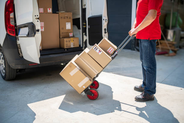 istock Senior male courier delivering at the receiver address. 1496576839