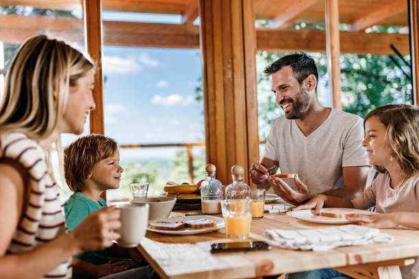 istock Happy family enjoying in their breakfast at dining table. 1496577081