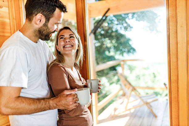 istock Young happy couple talking during morning coffee at home. 1496577512