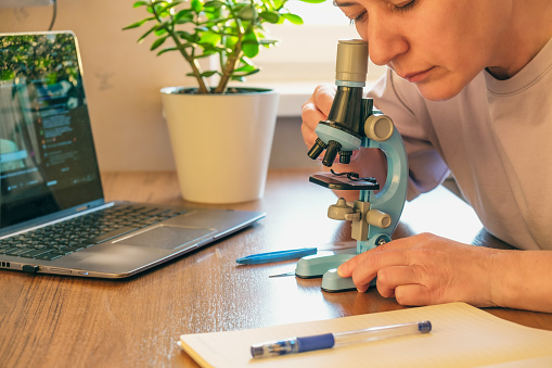 Microscope Homework Student Conducts Research Using A Microscope Doing Homework Online ...
