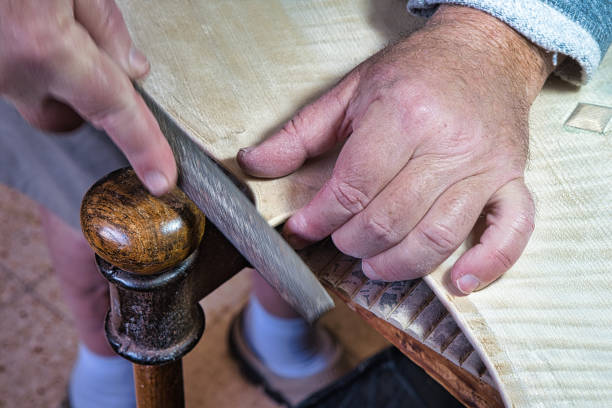 istock Master artisan luthier working on the creation of a cello, detailed work on wood. 1496578943