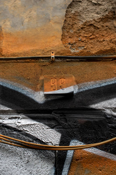 istock Old wall with house number and wires painted with graffiti 1496579275