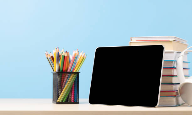 istock Tablet with colorful pencils and stack of books 1496579706