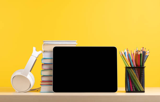 istock Tablet with colorful pencils and stack of books 1496579727
