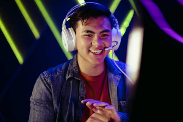 Male gamer looking at his pc screen with a smile, pleased with his performance