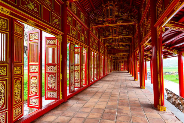 Corridor and red doors in the Forbidden Purple City of The Imperial City of Hue, Vietnam. stock photo