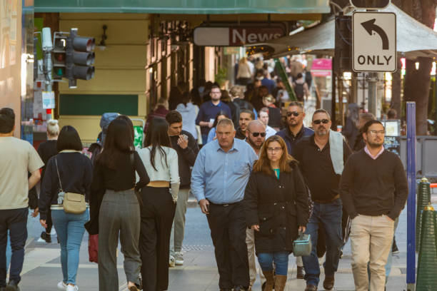 istock Crowd of commuters crossing a CBD street 1496584816