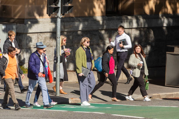 istock Crowd of commuters crossing a CBD street 1496584817