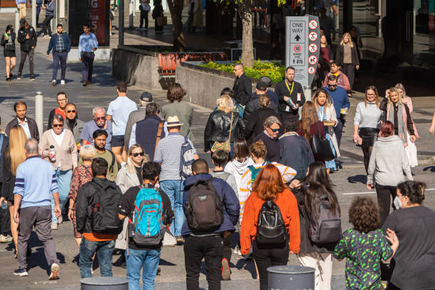 istock Crowd of commuters crossing a CBD street 1496584823