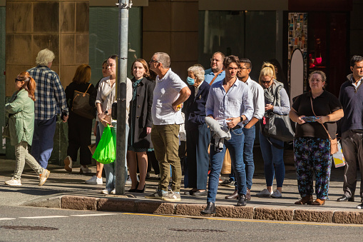 Crowd of commuters crossing the road in the Brisbane CBD