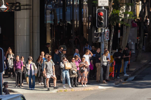 istock Crowd of commuters crossing a CBD street 1496584834