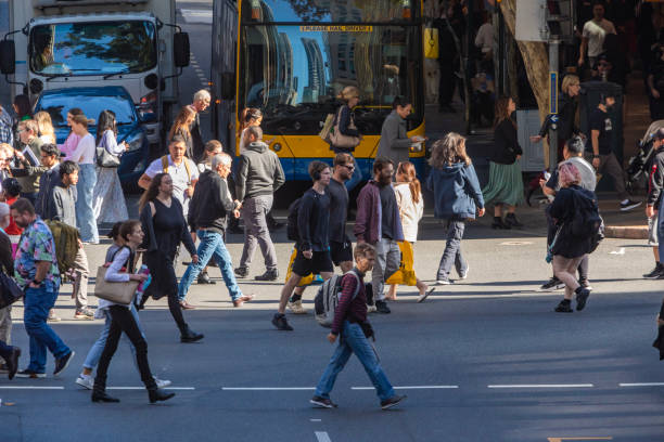 istock Crowd of commuters crossing a CBD street 1496584839