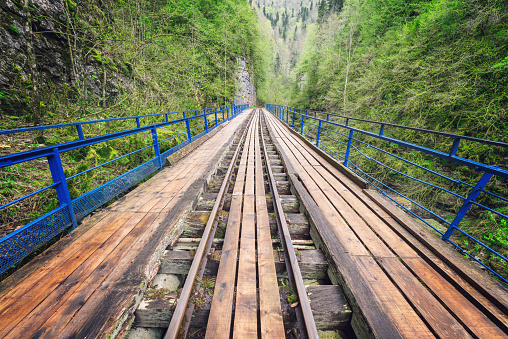 Narrow railway in the deep gorge. Caucasus. Russia.