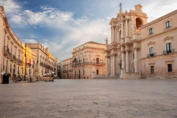 Cityscape image of historical centre of Syracuse, Sicily, Italy with old square and Syracuse Cathedral at sunrise.