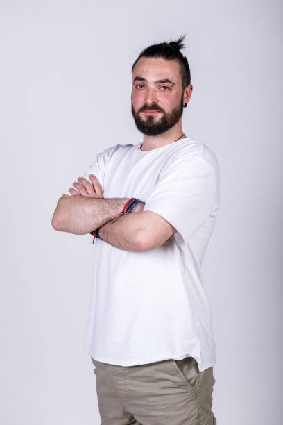 istock Charming young man standing against a white background, smiling at camera 1496589237
