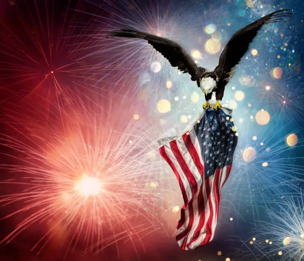 Eagle With American Flag Flies In The Fireworks With Bokeh Lights - Independence Day