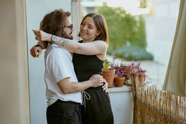 istock Smiling couple hugging and enjoying time together while standing at balcony. Good relationship time 1496589651