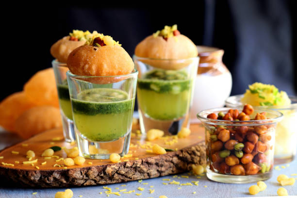 Pani Puri shots, Indian street snack made of fried puries, mint chutney, sprouts and boiled potatoes. Indian Chat. Golgappe, puchka, batase. copy space Pani Puri shots, Indian street snack made of fried puries, mint chutney, sprouts and boiled potatoes. Indian Chat. Golgappe, puchka, batase. copy space Pani Puri  stock pictures, royalty-free photos & images