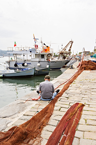 Port of the town of La Spezia in Italy, boats on the water fisherman with nets Liguria Italy