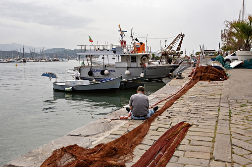 Port of the town of La Spezia in Italy, boats on the water fisherman with nets Liguria Italy