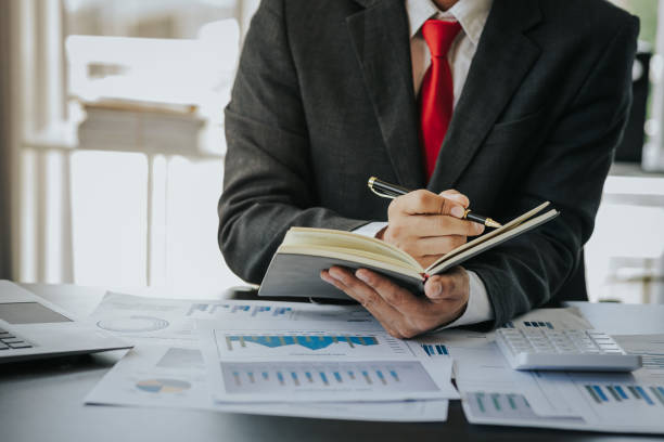 istock Close up work of businessman or accountant using calculator and laptop while analyzing business report in workplace financial planning and accounting concept 1496591256