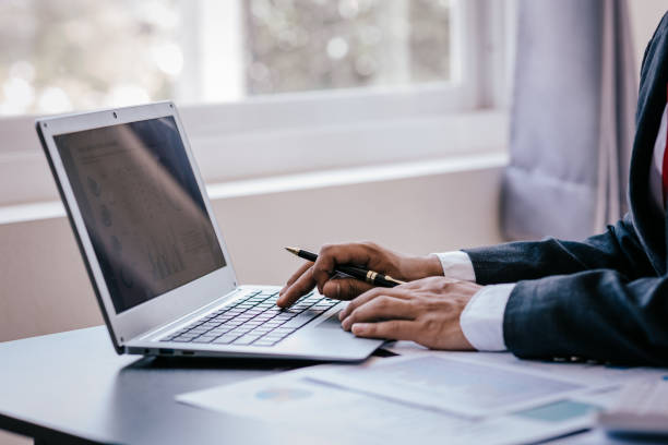 istock Close up work of businessman or accountant using calculator and laptop while analyzing business report in workplace financial planning and accounting concept 1496592906