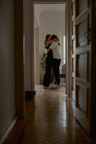 istock Romantic couple hugging and enjoying time together while standing at home. Good relationship time 1496595020