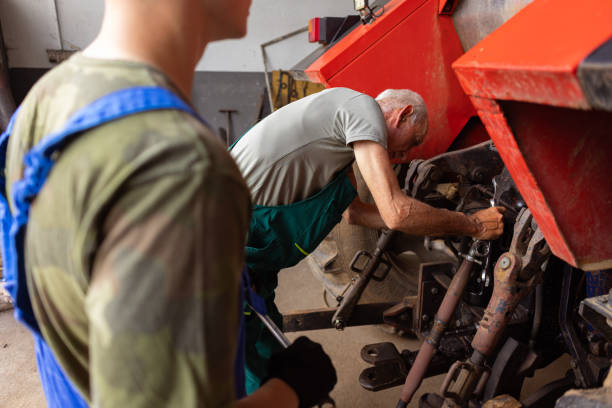 istock Father and Teenage Son Fixing a Tractor 1496596399