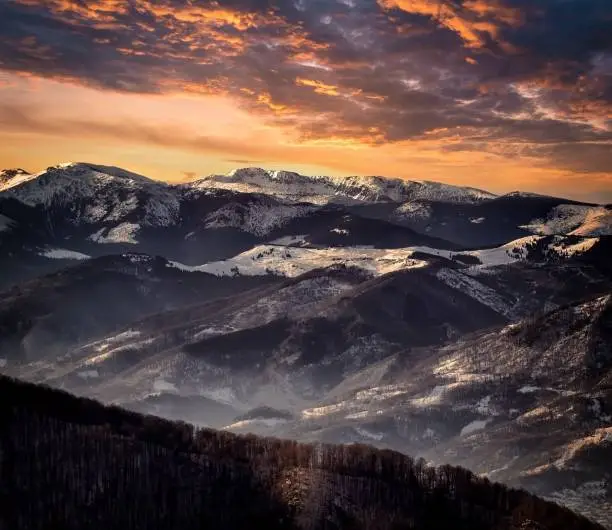 Scenic view of snow-capped mountains against a stunning sunset sky