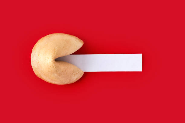Traditional fortune cookie with white empty paper for text. stock photo
