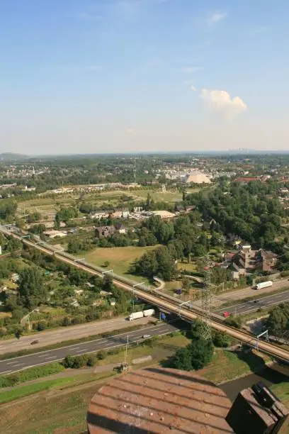 An aerial view of a bridge over roads surrounded by green vegetation. Oberhausen, Germany.