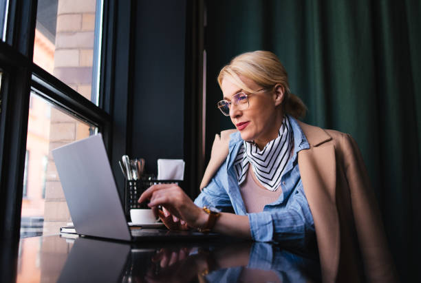 Happy Business Woman Using A Laptop Computer In The Cafe