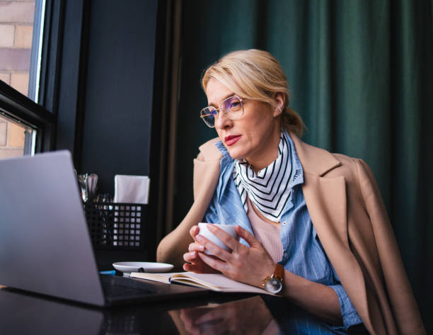 istock Happy Business Woman Using A Laptop Computer In The Cafe 1496604441