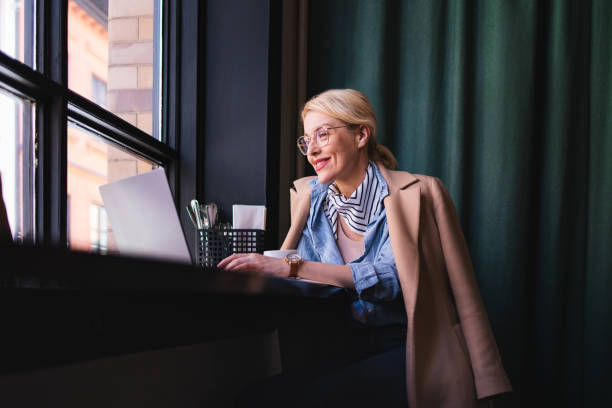 istock Happy Business Woman Using A Laptop Computer In The Cafe 1496604442
