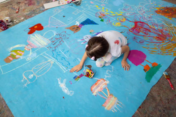 istock Girl draws with chalk 1496604499