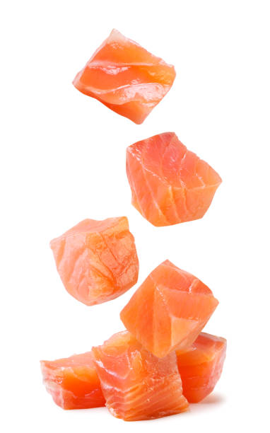 istock Trout cubes fall on a pile on a white background. Isolated 1496605130