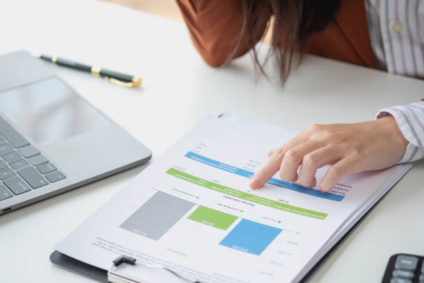 istock Financial advisor calculating numbers datasheets graphs charts reports marketing research development planning management strategy analysis financial accounting. Business office concept. 1496607307