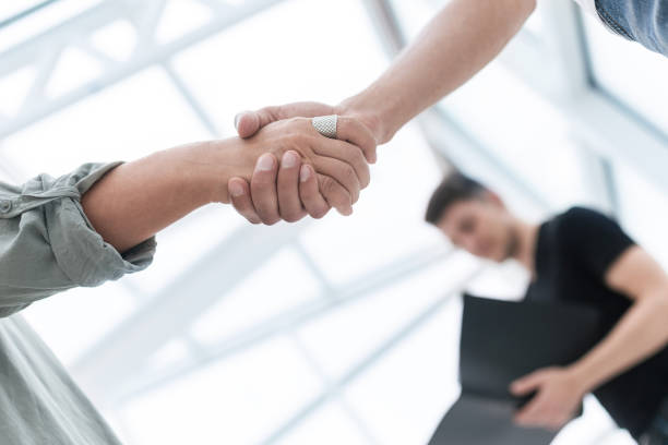 istock close up. business handshake over blurry background 1496608657